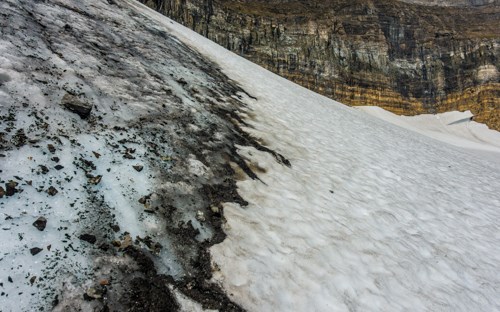 Can you see the difference between snow and ice? snow and ice with rockes behind