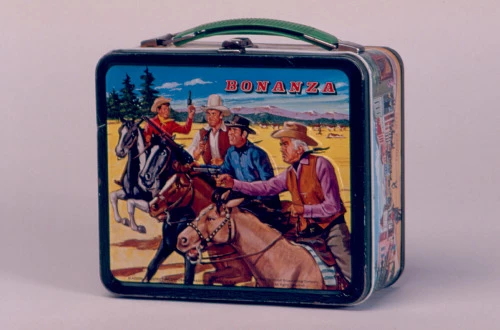A metal lunch box emblazoned with an illustration of a scene from the television series Bonanza A metal lunch box emblazoned with an illustration of a scene from the television series Bonanza