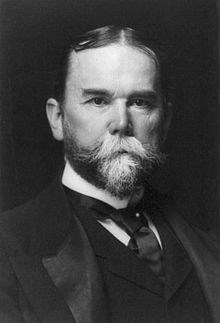 man with a suit jacket, tie and vest- the man has a beard that is starting to get white