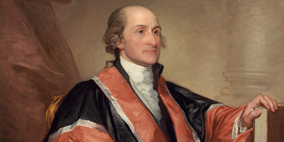 A seated John Jay in judge's black and red robe.