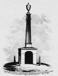 A monument with a large square base that has an arched opening in the side. On top of the base is a column that leads to an urn shaped top.