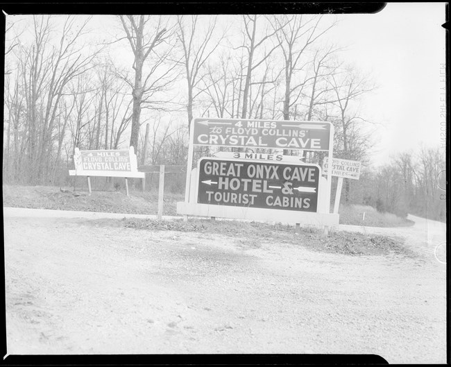 A black and white photo of road signs for area caves