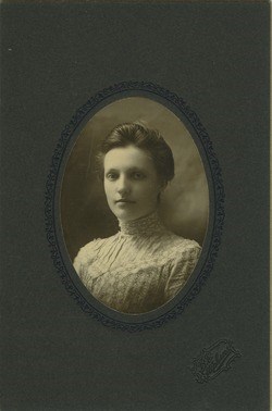 Studio portrait of a young Mary Rolfe wearing a high-necked dress.