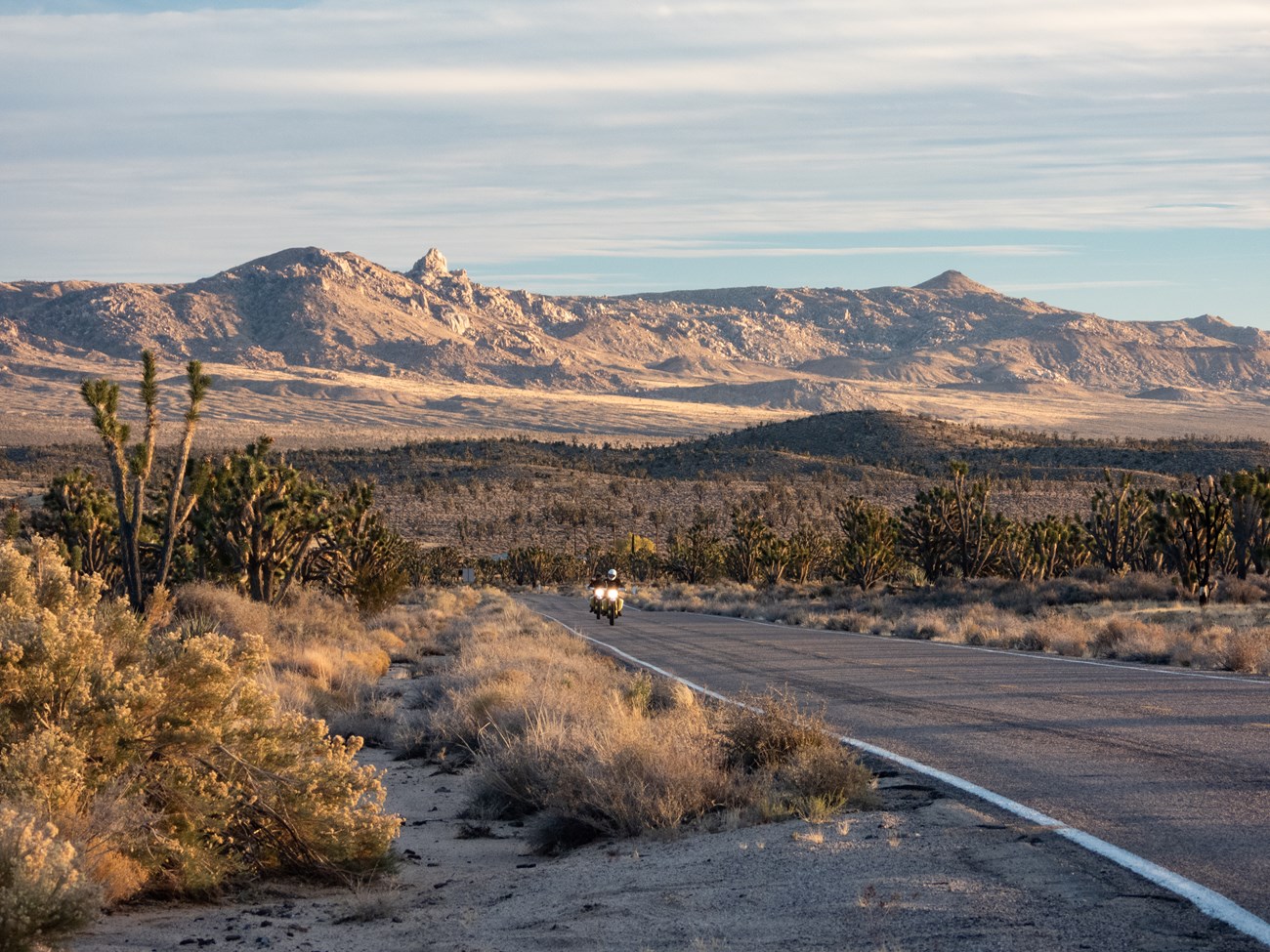 two motorcyclists on a desert road