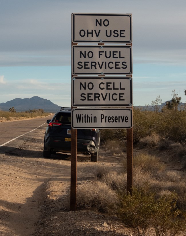 signboard that reads "no OHV use, no fuel services, no cell service within preserve"