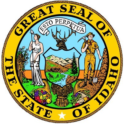 The seal of the State of Idaho. A woman, a man, rivers, mountains, animals, and cornucopias in a circle.