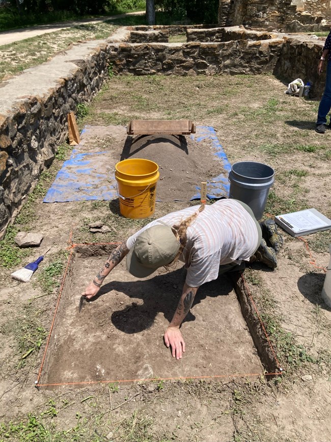 Person excavating an archeological unit