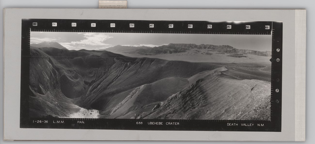 Panoramic photograph of a deep barren crater