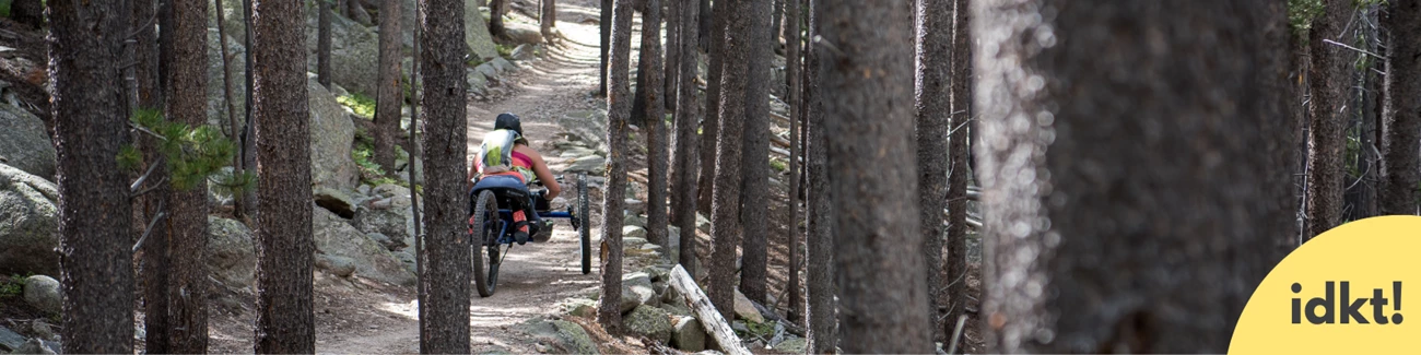 Wilderness is for all a person in an all-terrain wheelchair moves down a trail in a forest