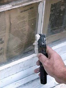 man reglazing a window