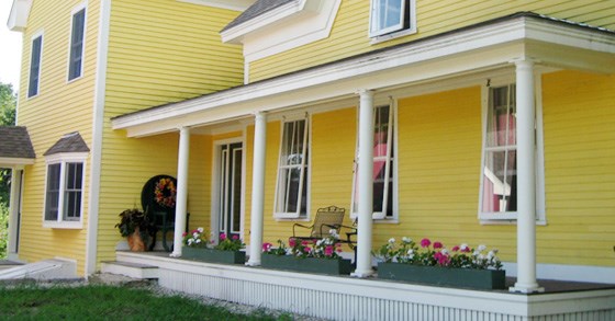 yellow house with wood storm windows