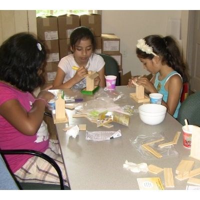 lt= Youth doing arts and crafts at a table.