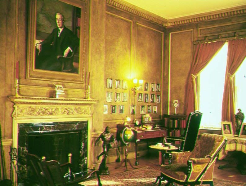 Image of Wilson's library with fireplace and chairs.
