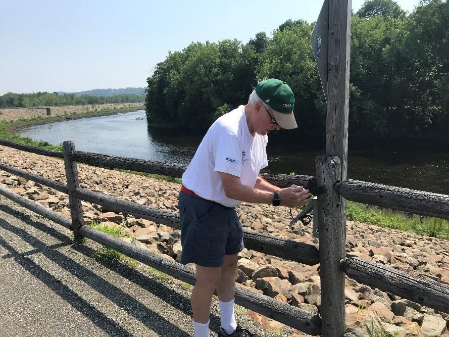 Jack Walsh of the Naugatuck River Greenway Steering Committee monitors the trail counter on the Naugatuck River Greenway in Derby. Kendra Barat, National Park Service photo.