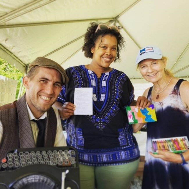 Poet Brian Sonia-Wallace (left) with Boston Harbor Islands National Recreation Area visitors holding their personalized instant-poem. Photo courtesy of Brian Sonia-Wallace.