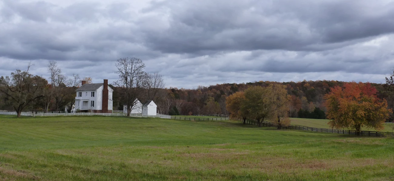 8132157217_88804877de_o_peershouse_Bruce_Washburn_APCO_CMS Peers house as viewed from a distance across a green field with storm clouds in the background