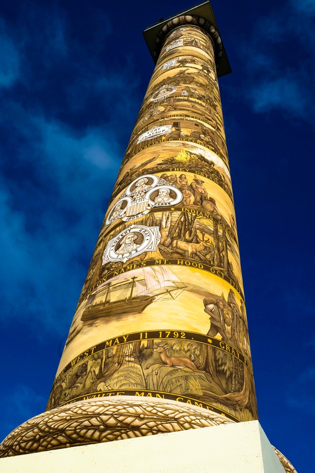 upclose photograph of tower with artwork