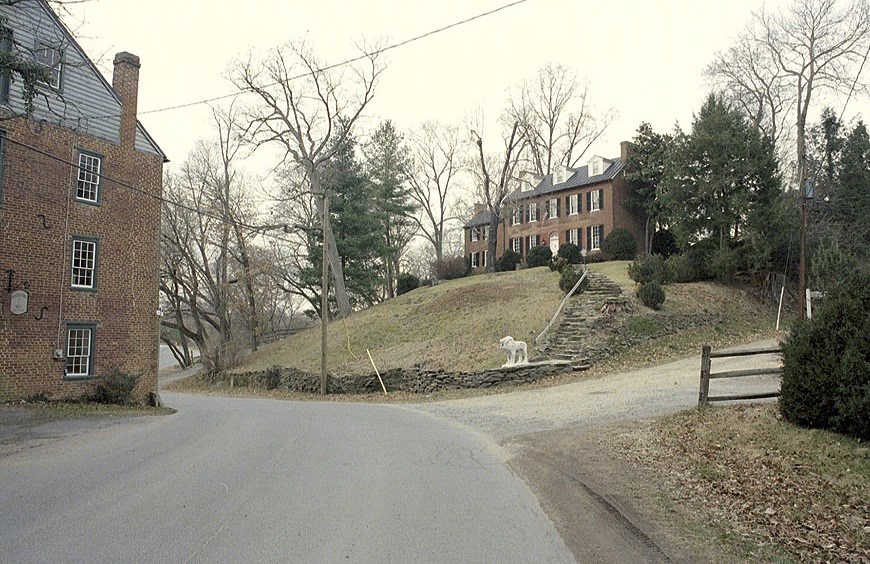 Large brick house on a hill.