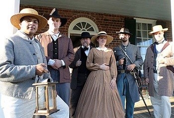 Civil War era reenactors standing on a porch