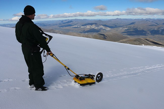 ArcticArch_IMG_2585_web An archaeologist uses ground-penetrating radar to search for archaeological sites in the Arctic.