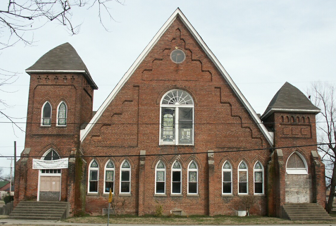 Brick building with arched windows.