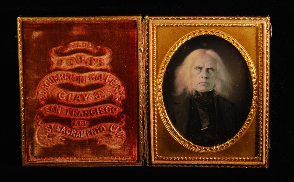 Daguerreotype of white-haired man in case with imprinted velvet interior