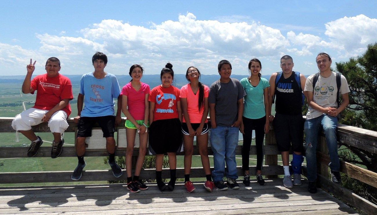 Nine young people standing at an overlook.