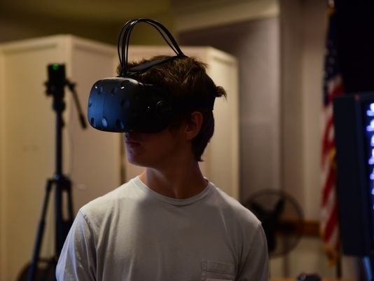 Young man wears virtual reality glasses.