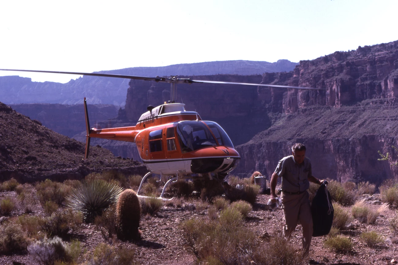 Helicopter dropping off field supplies at Cove Canyon in the Grand Canyon in March 1982. Helicopter dropping off field supplies at Cove Canyon in the Grand Canyon in March 1982.