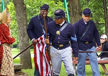 Civil War reeanactors carrying a US flag