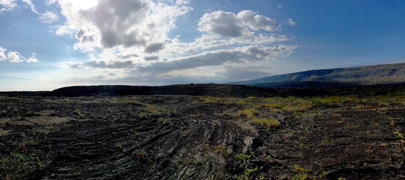 Puʻuloa A small dome covered in a desolate volcanic area.