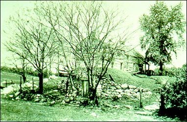 The Locher/Poffenberger cabin from a 1930s photograph, showing the cold cellar and stone walkway.