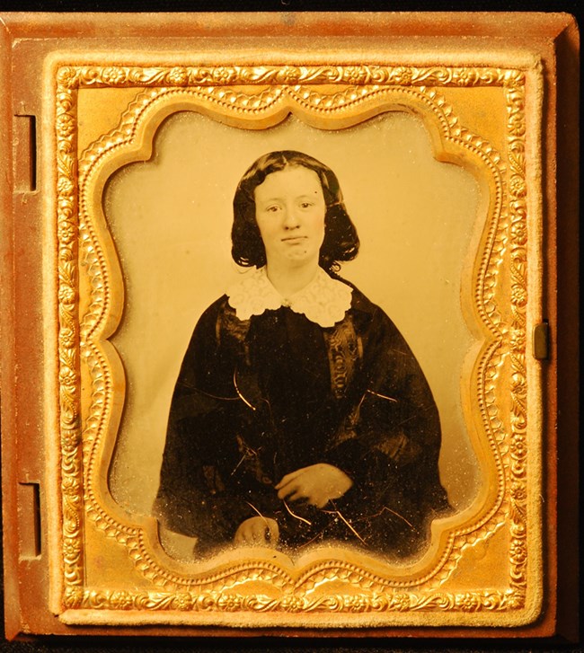 Ambrotype photograph portrait of a young woman in a dark dress with a white lace collar