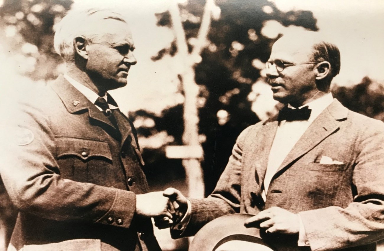 National Park Service Director Stephen Mather with Bureau of Public Roads Western Field Director Lawrence Hewes Shaking Hands. National Park Service Director Stephen Mather with Bureau of Public Roads Western Field Director Lawrence Hewes Shaking Hands.