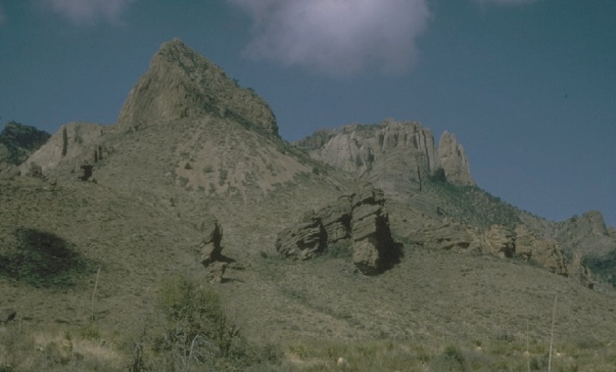 view looking up at rock cap on mountains