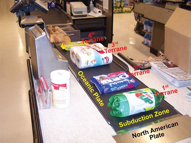Safeway Tectonics-1 grocery store conveyor belt with several products laid out