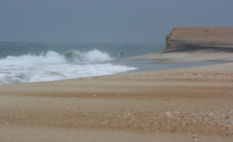 beach and low bluff, storm waves breaking