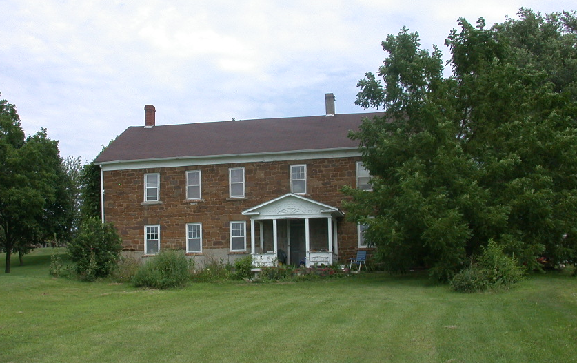 Stone house among trees.