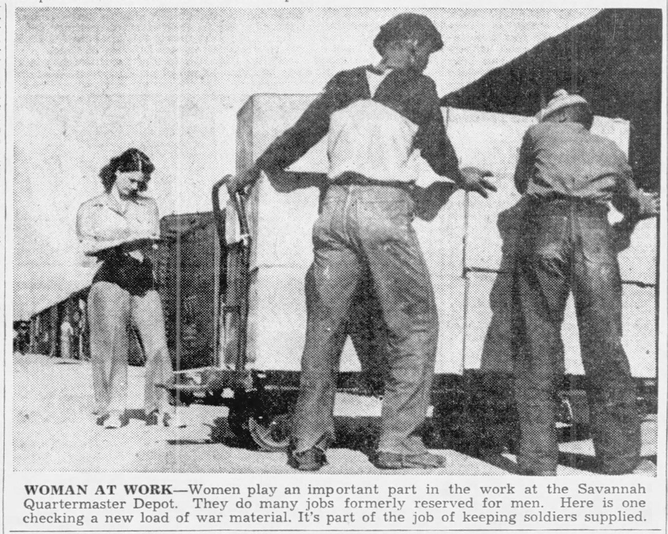 Woman at Work Black and white photo of a white woman with a clipboard and two African American men moving materials