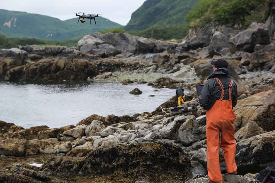 A researcher employs a UAS on the intertidal coastal zone.