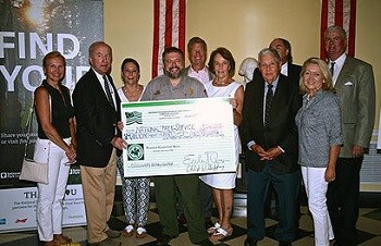 Members of the Washington Association of New Jersey and a ranger holding a large check