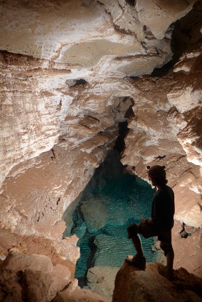 caver viewing underground lake