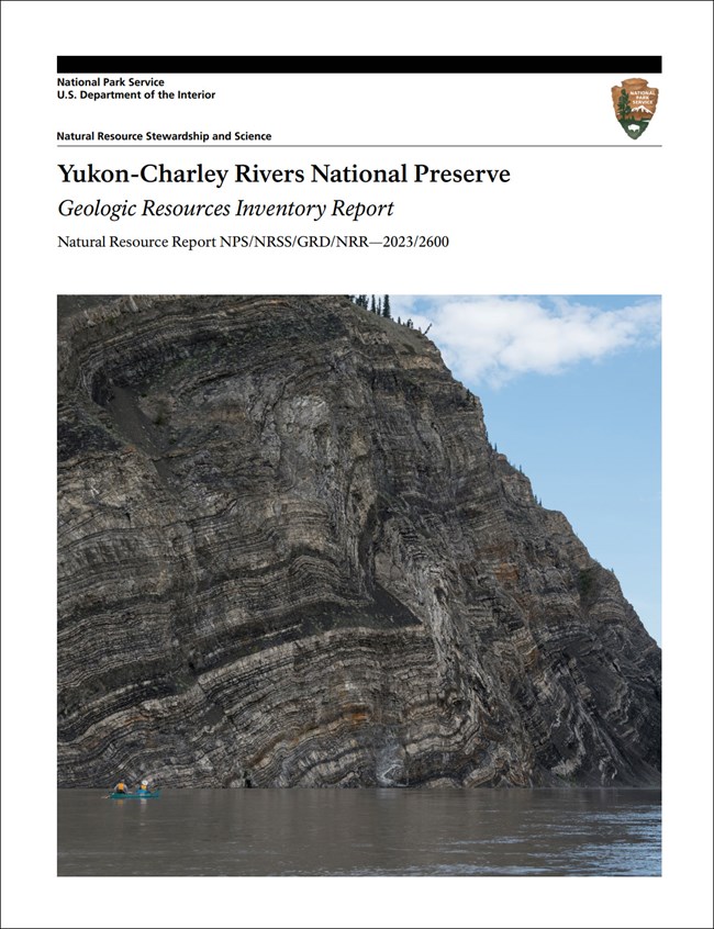Image of report cover with photo of a riverside rock cliff.