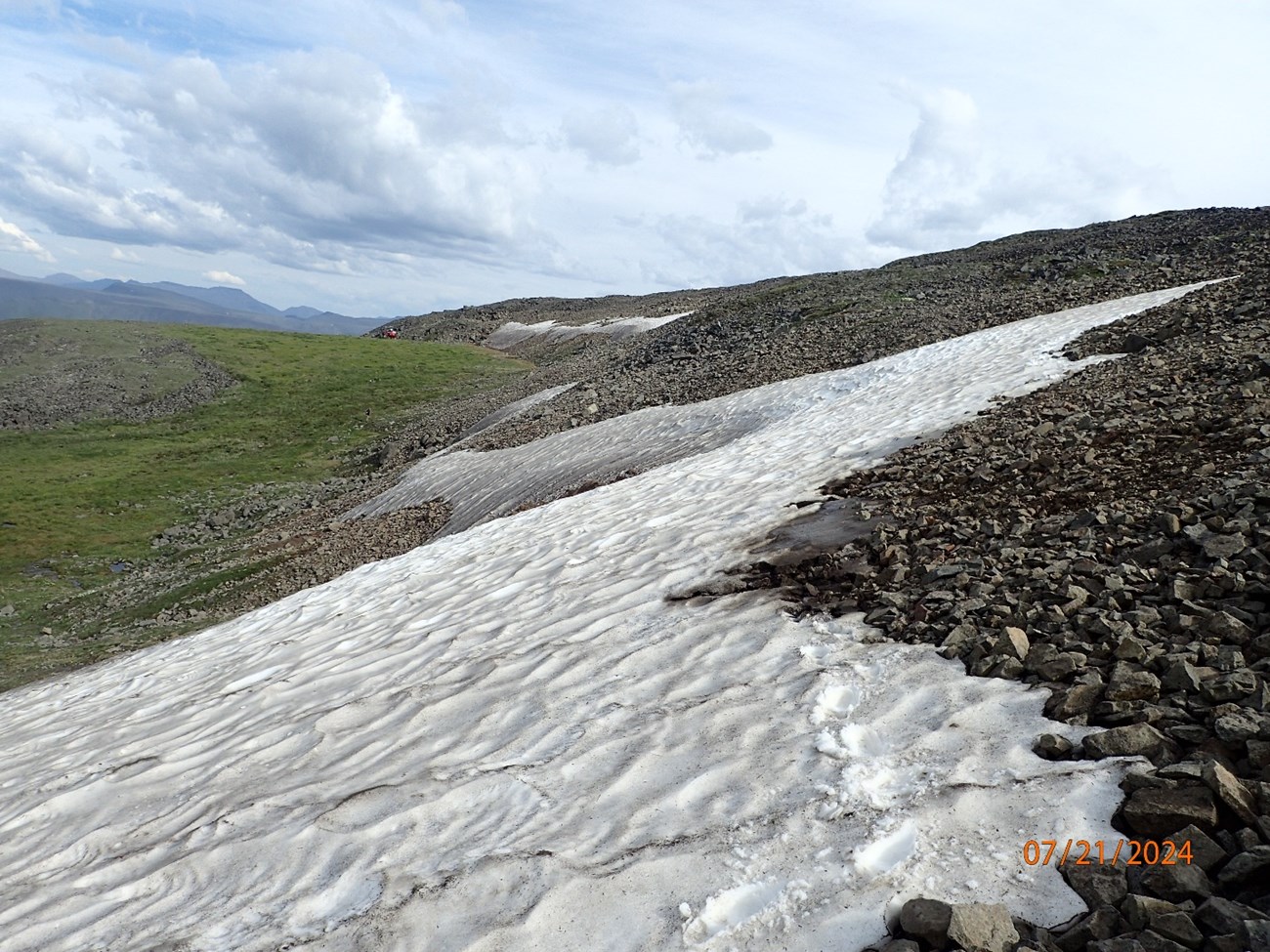 Snow and ice covers a portion of a rocky slope, in a photo dated 07/21/2024. Snow and ice covers a portion of a rocky slope, in a photo dated 07/21/2024.