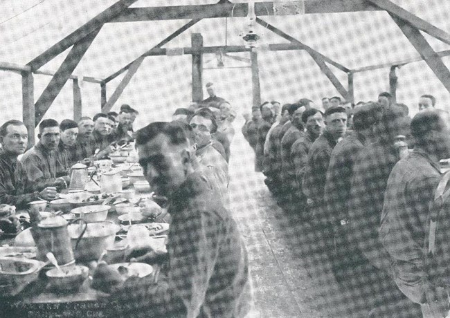 Soldiers in camp SPD soldiers sit at a table and eat a meal