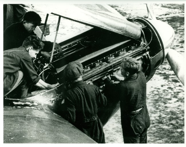 Photo of mechanics working on engine