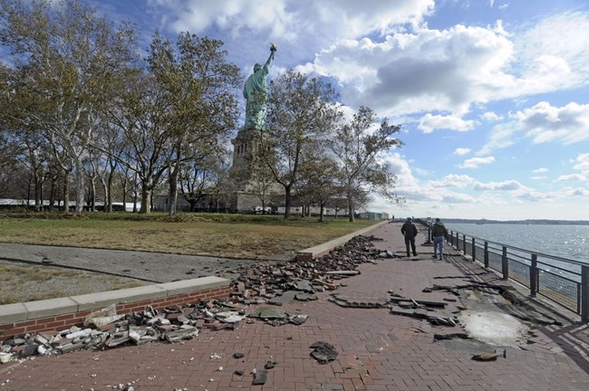 bricks an concrete litter the walkway at the Statue of Liberty after Hurricane Sandy