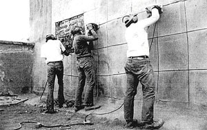 Men work on wall.