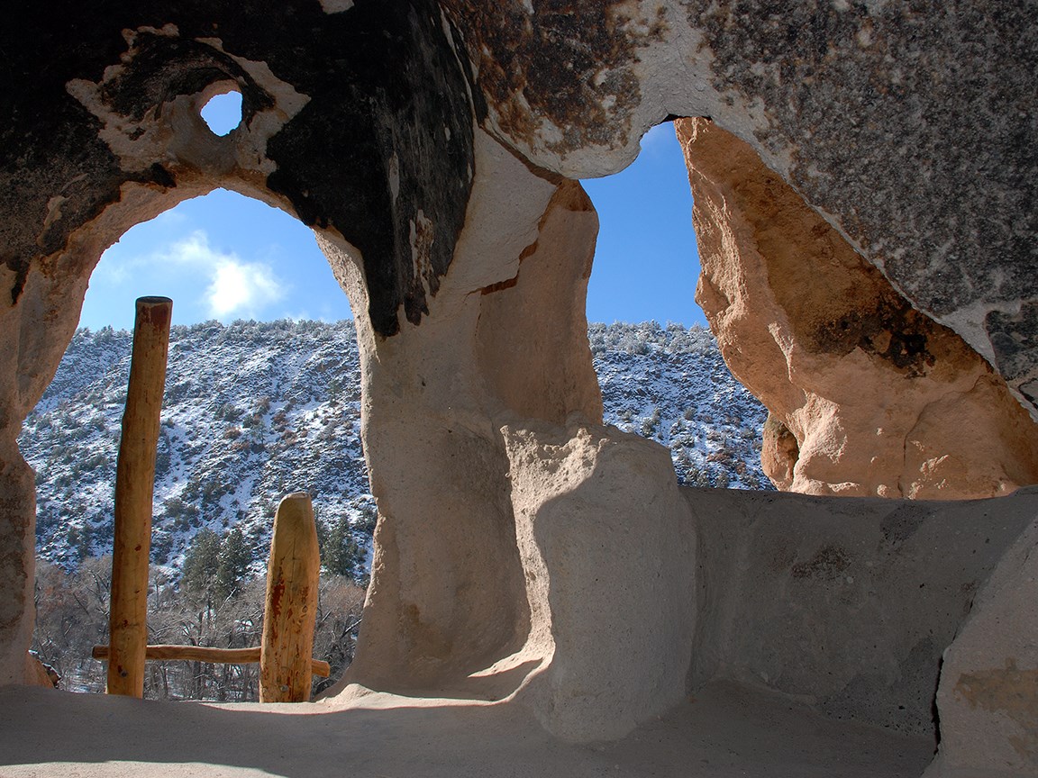A snowy view from inside a cavate (excavated cave).