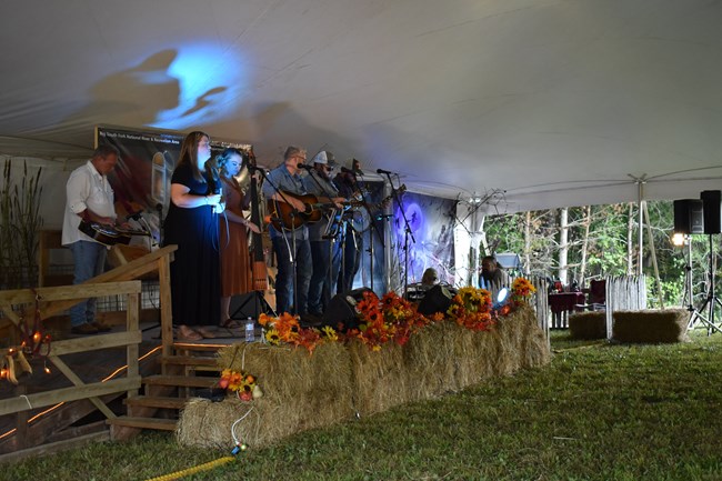 Musicians on stage performing at the Storytelling event.